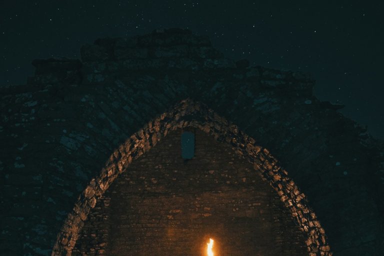Night ruin lit by a torch for an urbex gear checklist