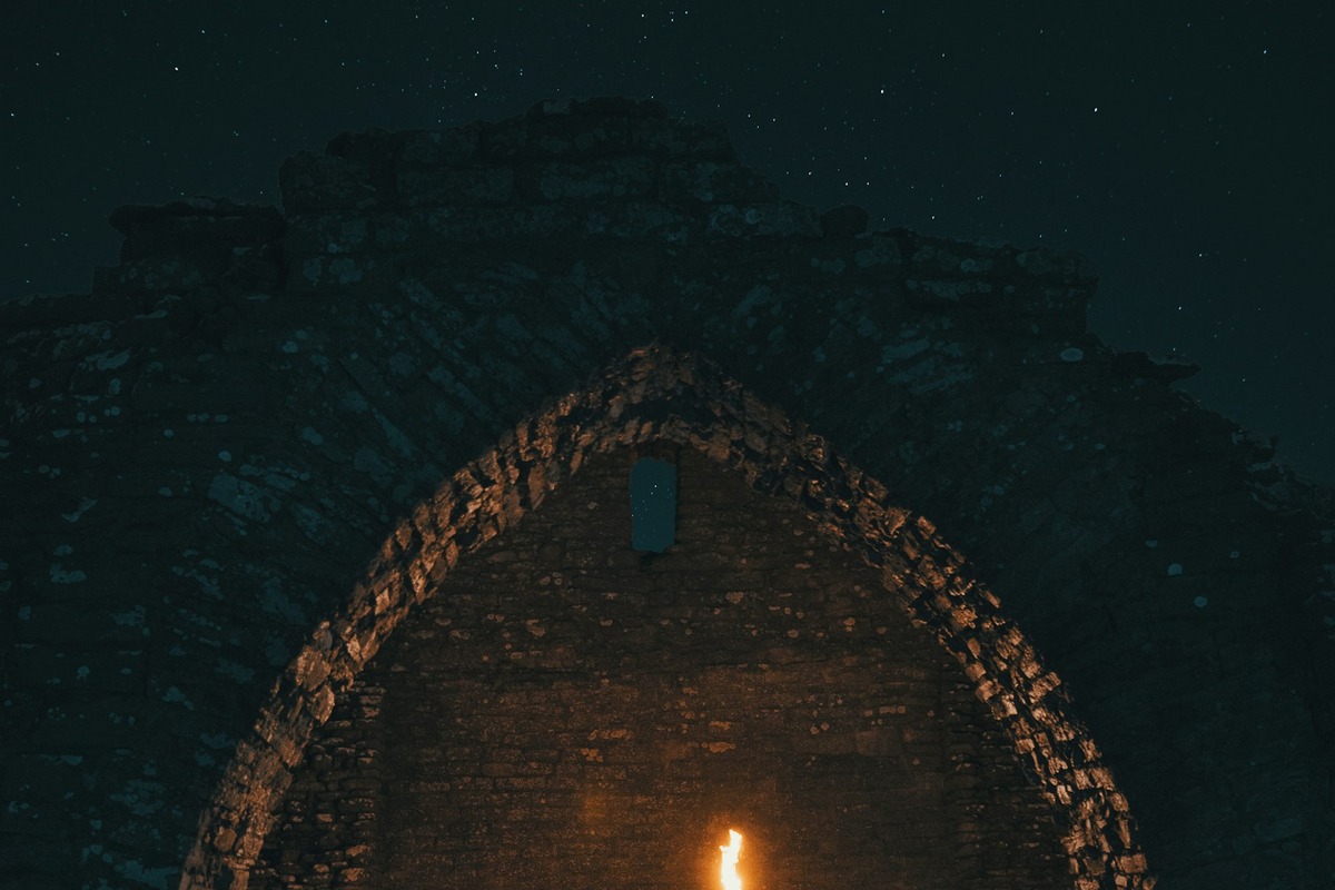 Night ruin lit by a torch for an urbex gear checklist